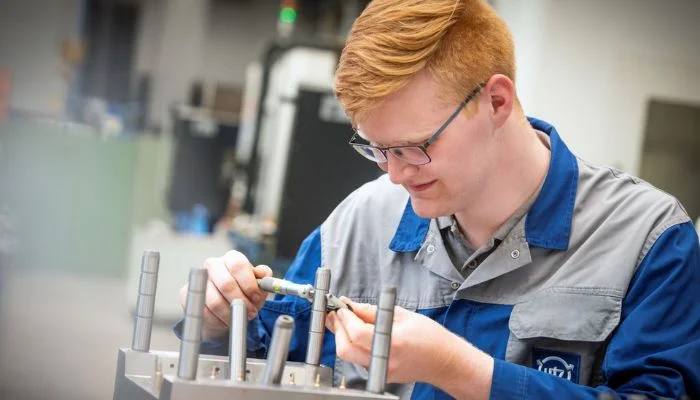 Utz trainee learning how to operate machinery